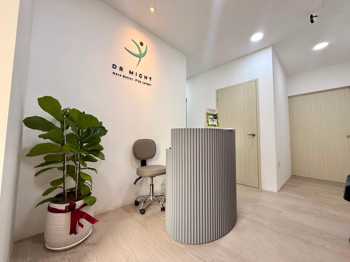 The reception area at DR MIGHT Vitality Clinic, with the clinic's logo lit on a white wall